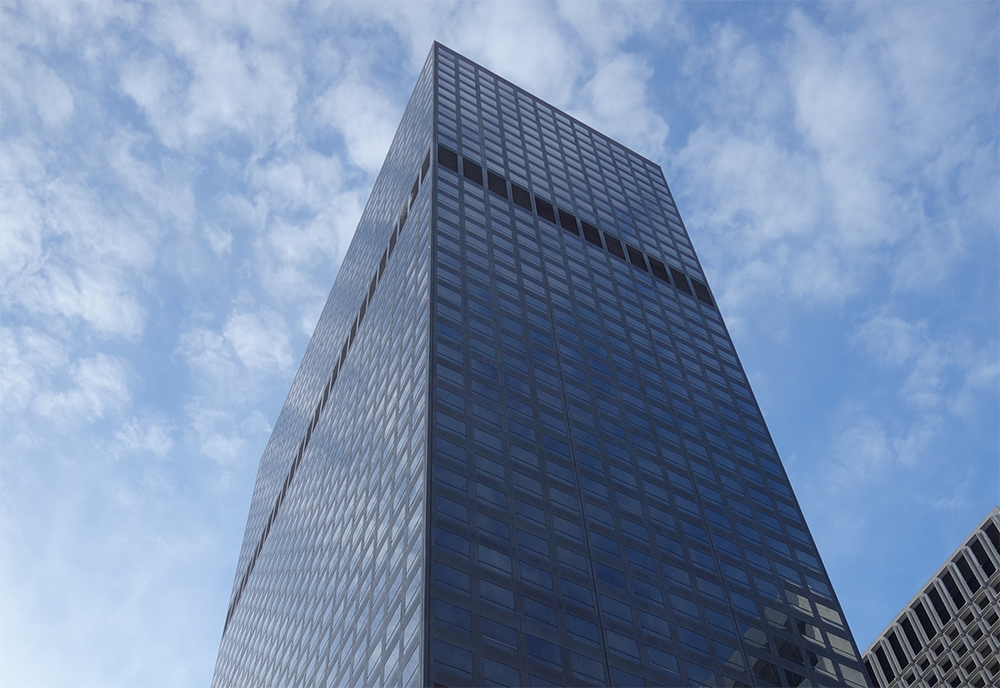 Corner image of the Bloomberg tower looking up toward the sky.