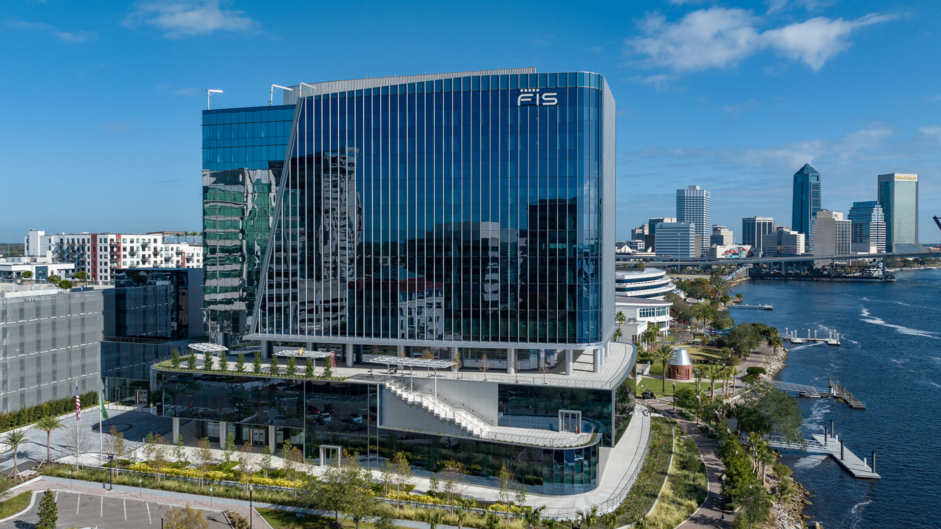 Fidelity Investment Services building center overlooking the harbor and other, tall office buildings in the background.