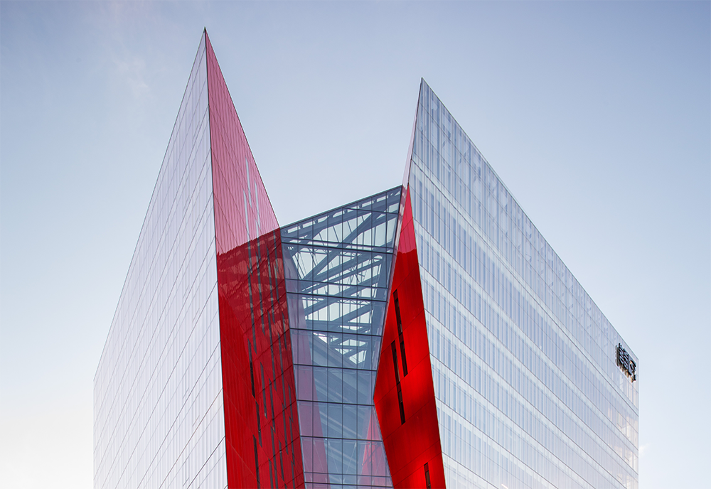Picture of the top of the Ilot Balmoral highlighting the sharp angles and modern architecture with an overcast sky in the background.