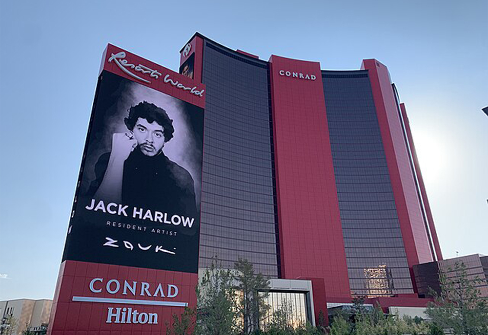 Resorts World Las Vegas exterior with a billboard highlighting Jack Harlow's residency at the hotel and venue.