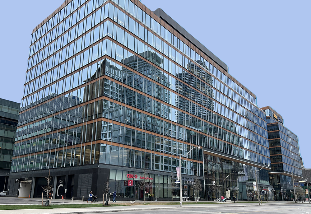 Waterfront Innovation Center shown from a side view with a man walking his dog and a woman pushing a baby carriage.