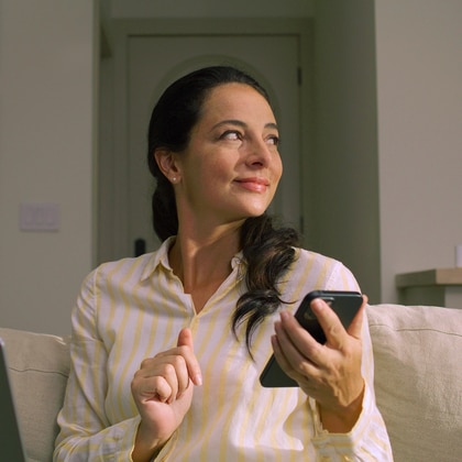 Woman with smartphone sitting on a couch