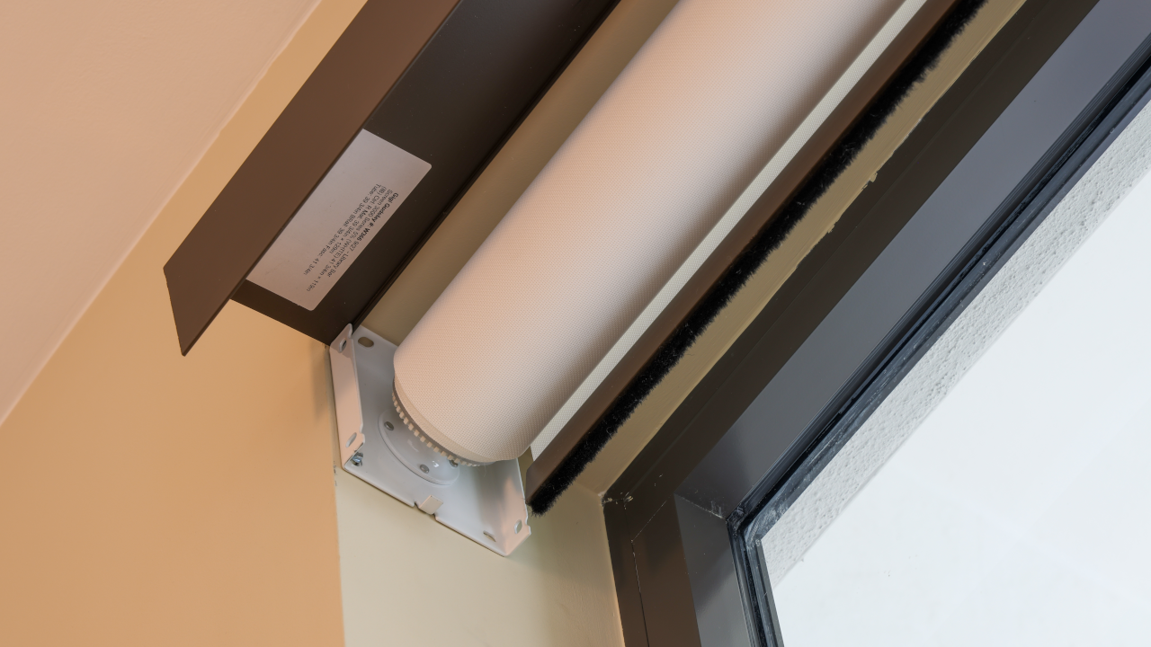 Close up of a Power over Ethernet (PoE) motor setup in a complete window rolling shade installation.
